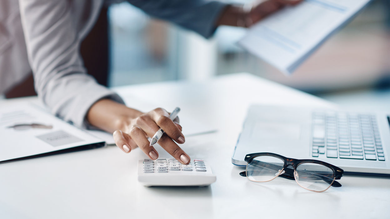 cropped-shot-of-a-businesswoman-using-a-calculator-2022-10-04-23-43-52-utc