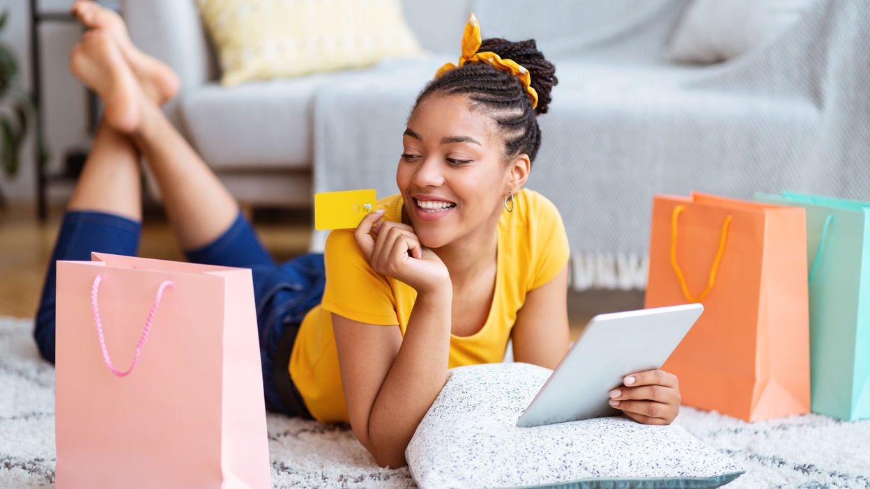 black-lady-using-tablet-and-credit-card-at-home-2022-12-16-08-51-22-utc