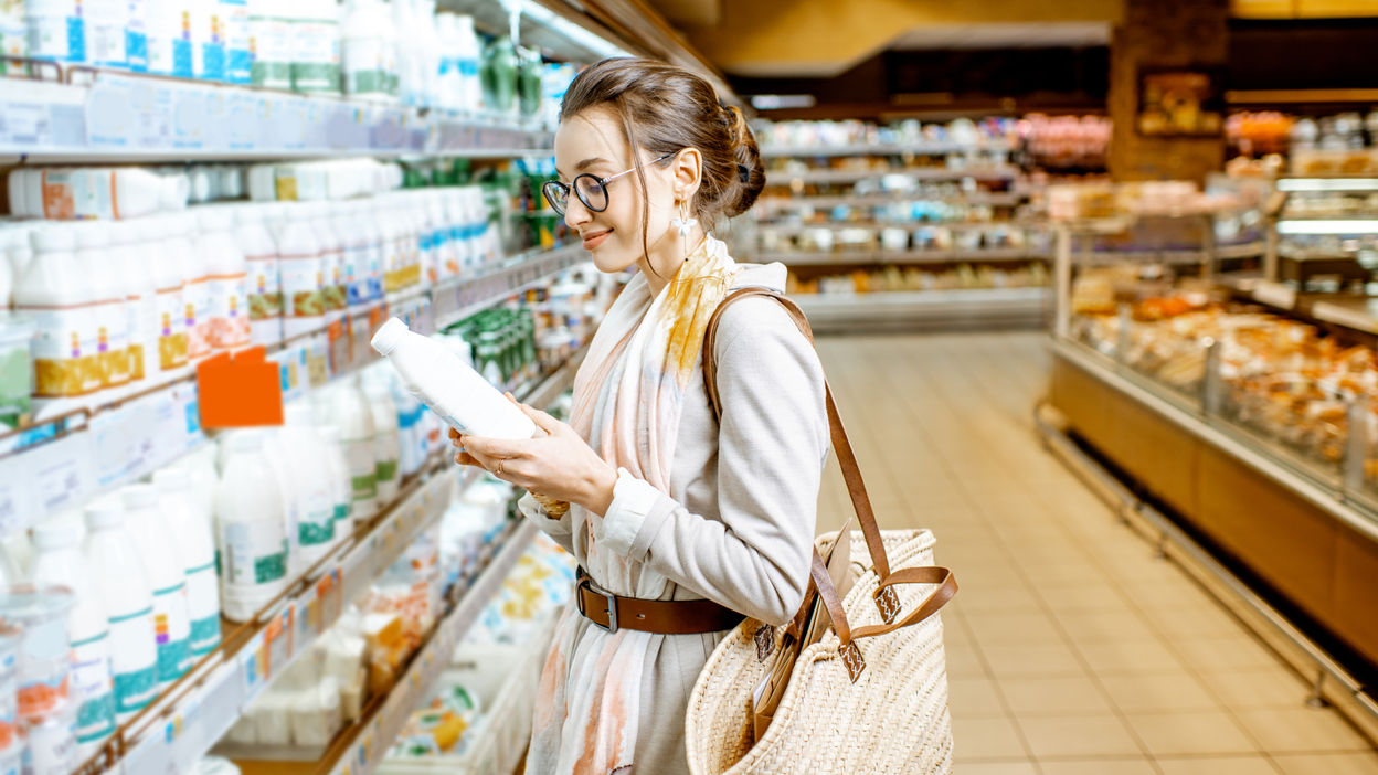 woman-buying-milk-in-the-supermarket-2022-01-19-00-17-29-utc