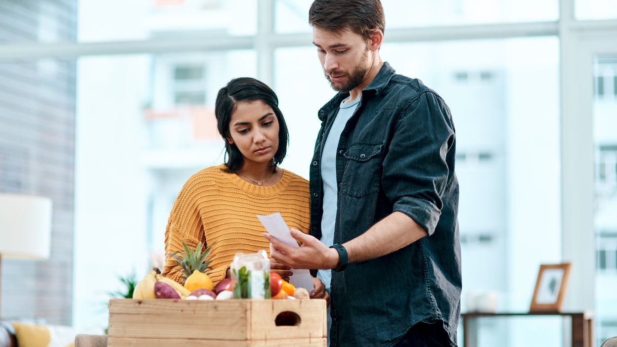 shot-of-a-young-couple-going-through-their-receipt-2022-12-30-00-25-17-utc