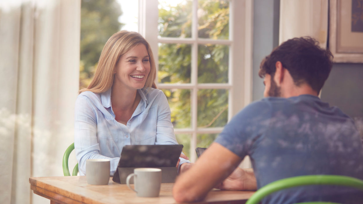 couple-with-digital-tablet-sitting-at-table-workin-2021-08-29-21-53-24-utc