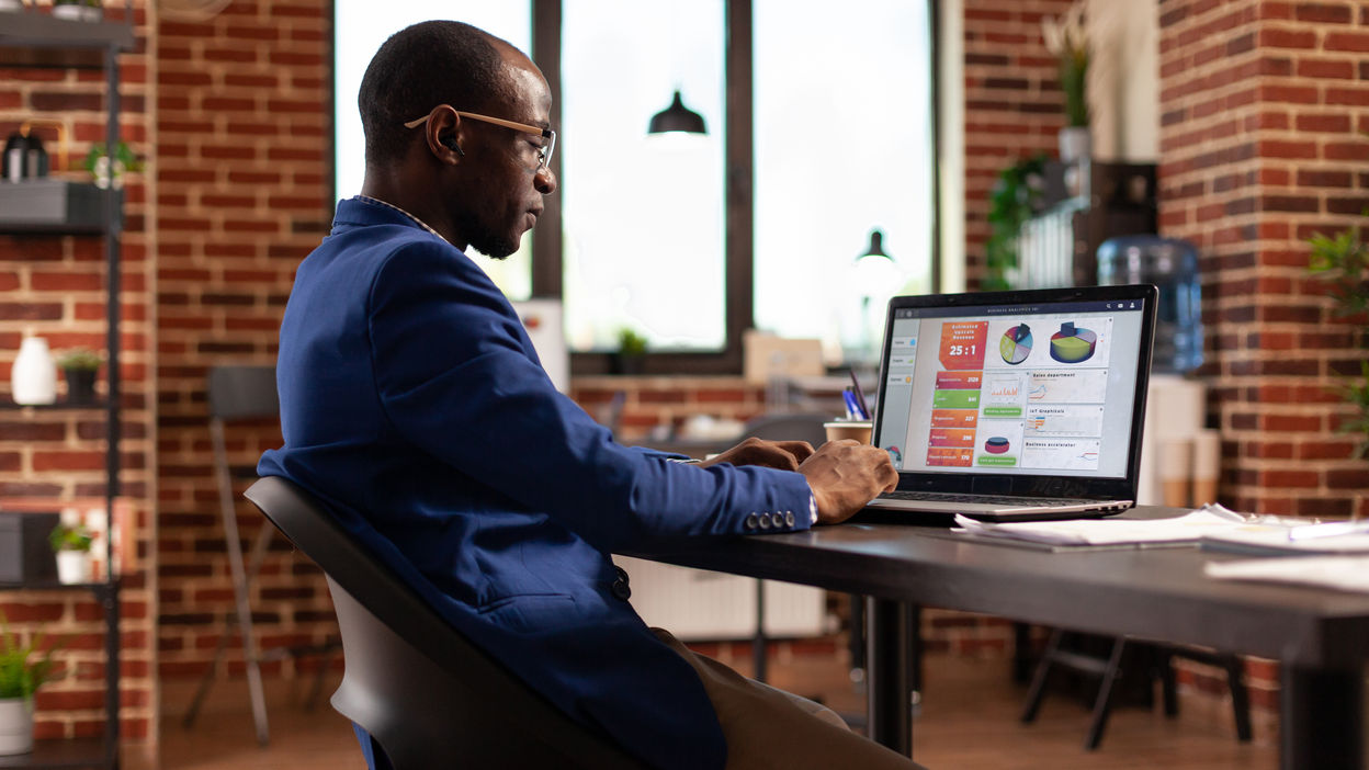 african-american-person-using-laptop-to-work-on-bu-2021-12-09-17-51-52-utc