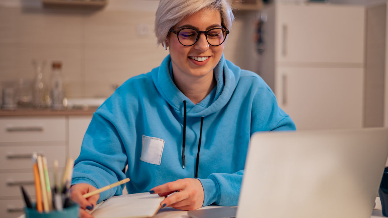 woman-working-on-a-laptop-in-the-kitchen-at-home-2022-11-24-02-42-34-utc