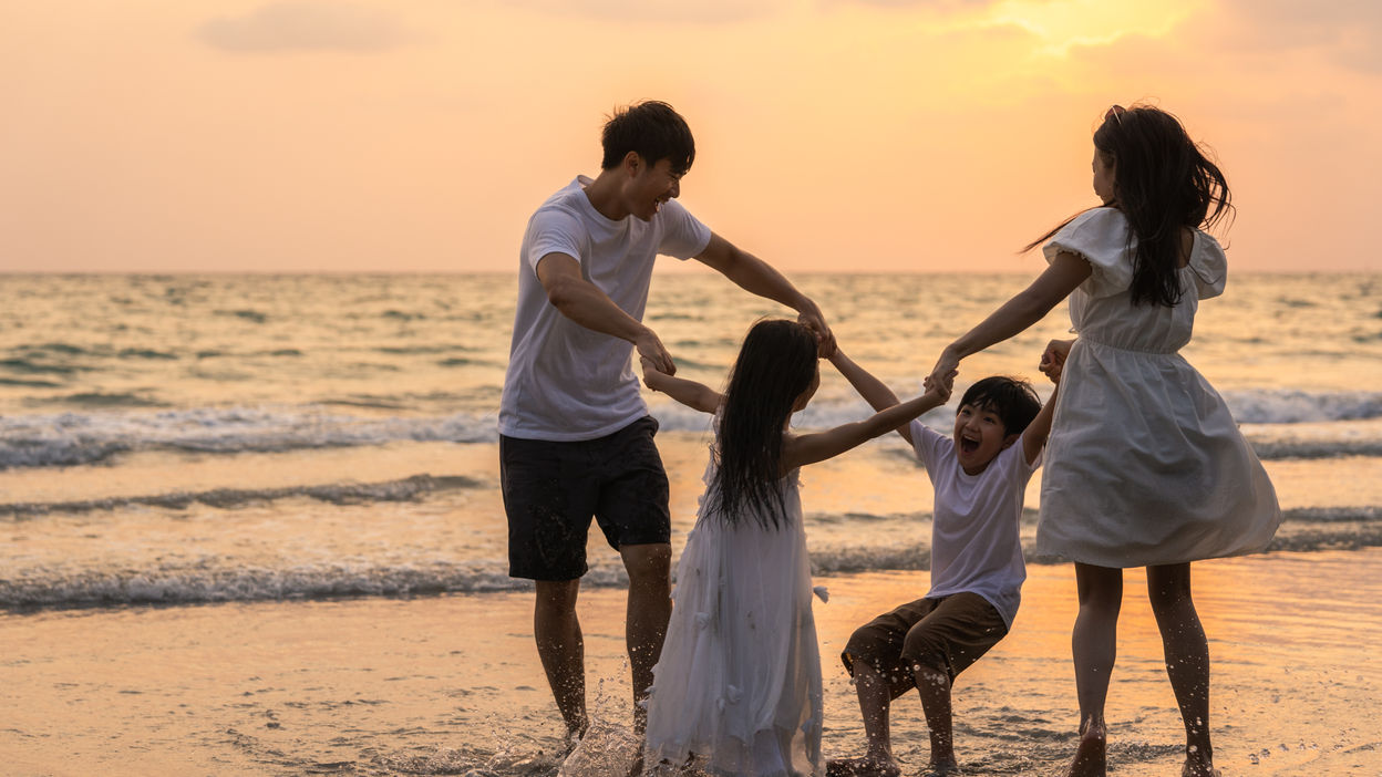 asian-young-happy-family-enjoy-vacation-on-beach-i-2022-02-01-22-38-16-utc