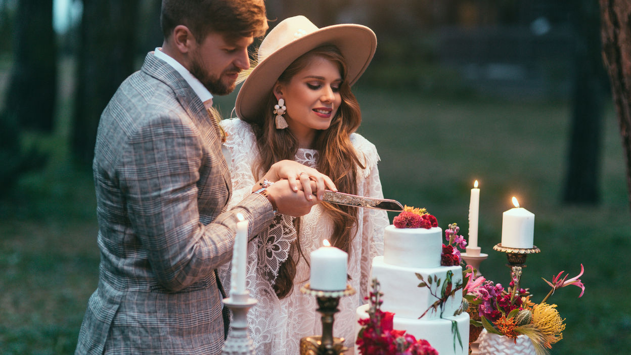 beautiful-happy-couple-cutting-wedding-cake-2022-12-16-17-37-59-utc