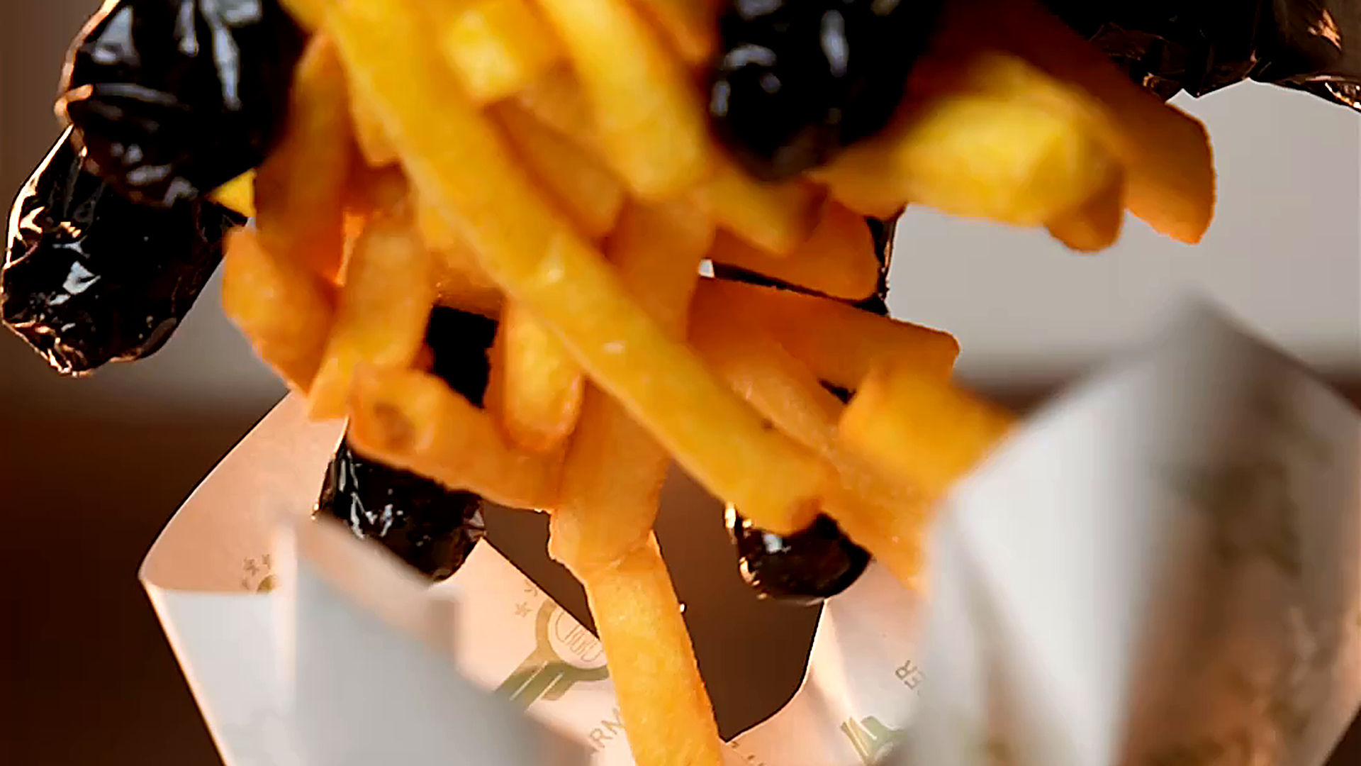 Close up of fries being tossed in a kitchen at Army Burger