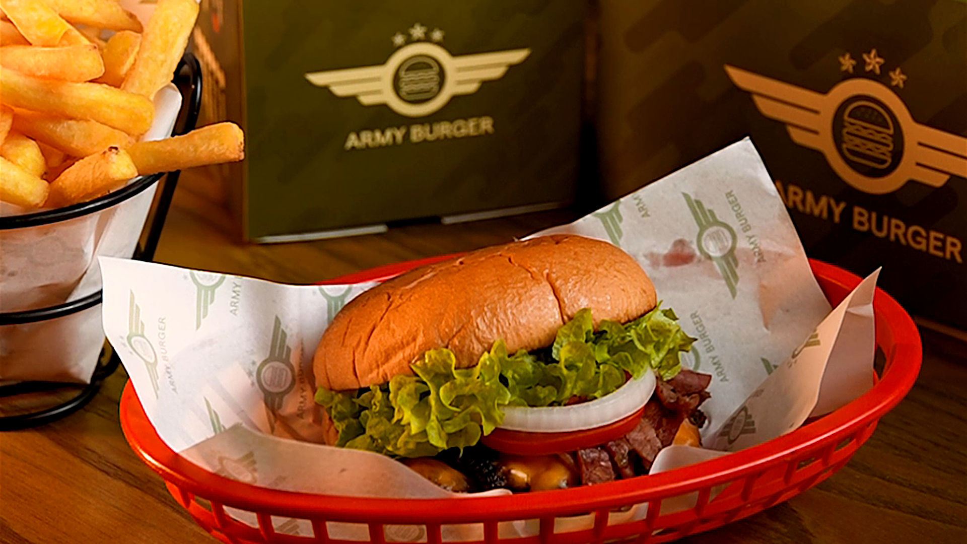 Army Burger spread with burgers and fries in branded packaging