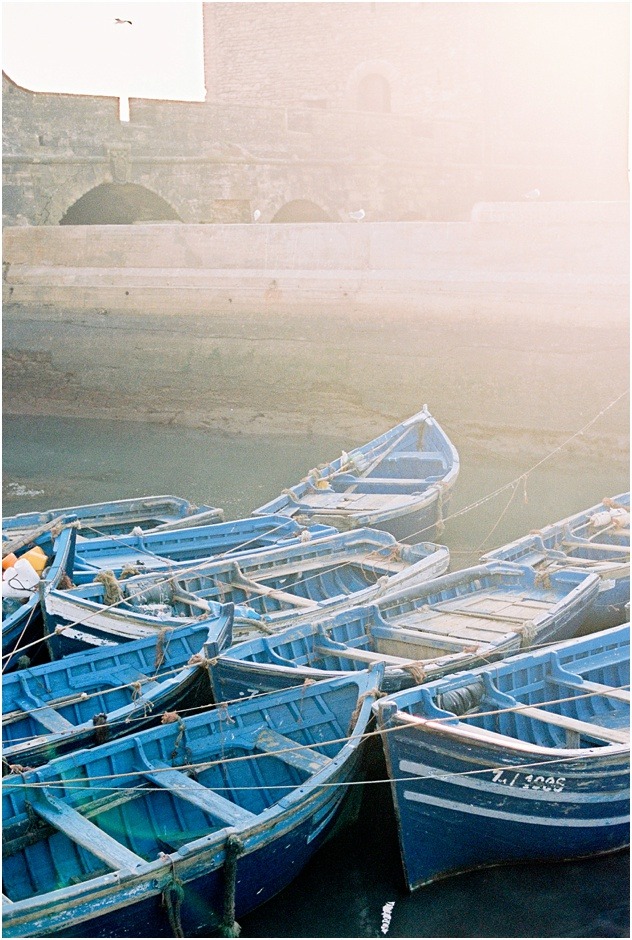 Blue fishing boats at sunset in Essaouira