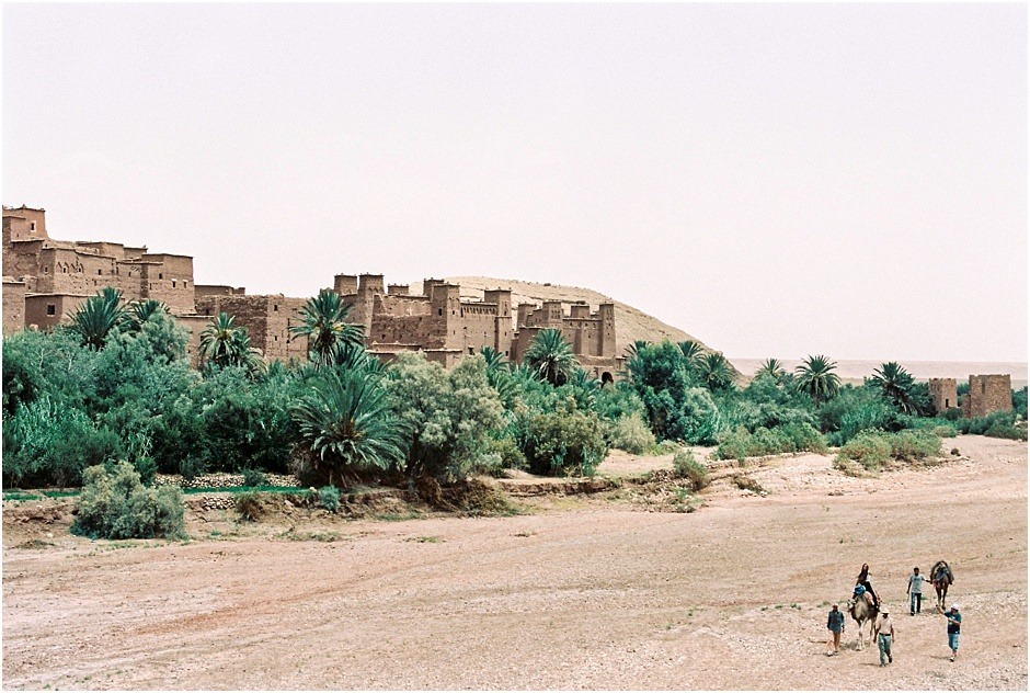 Men trekking with camels by Ksar of Ait-Ben-Haddou