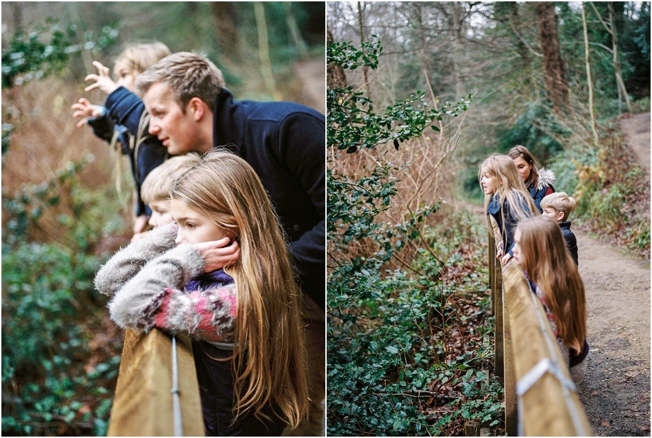 Family leaning on fence looking at view during a natural family winter shoot.