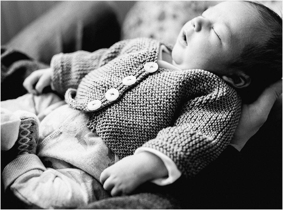 Black and white newborn photograph of baby sleeping.