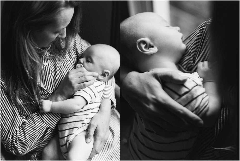 Black and white baby asleep in arms of mother