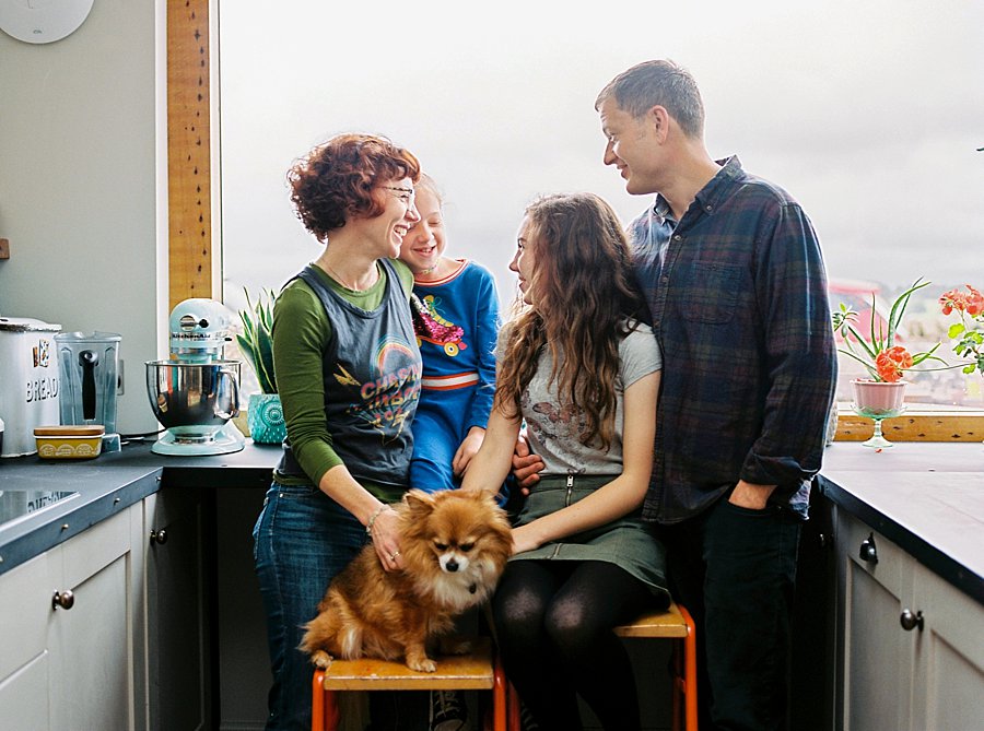 Family and dog laughing together in kitchen | Colour Family Photography