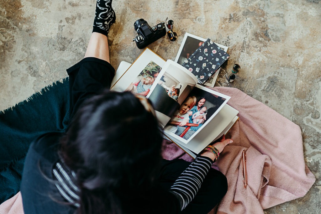 Images of Photographer flicking through photo album