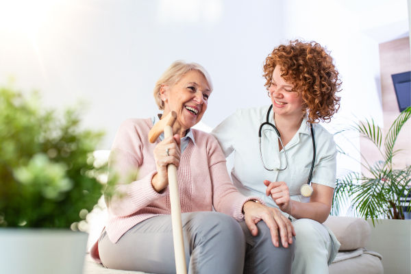 friendly-relationship-smiling-caregiver-uniform-happy-elderly-woman-supportive-young-nurse-looking-senior-woman 1 (1)