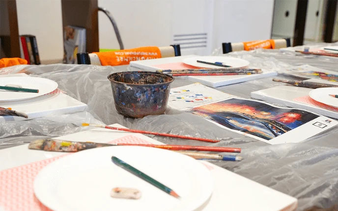 Children around a table working on a colourful craft project