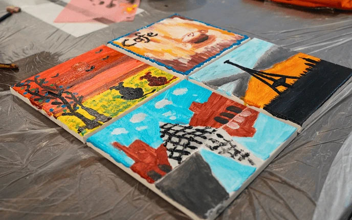 Four finished canvases laid out to dry after a session