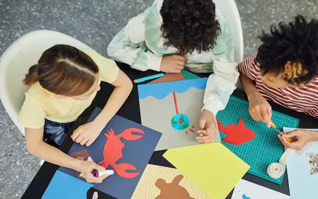 Children painting canvases at a kids art jamming session in Singapore