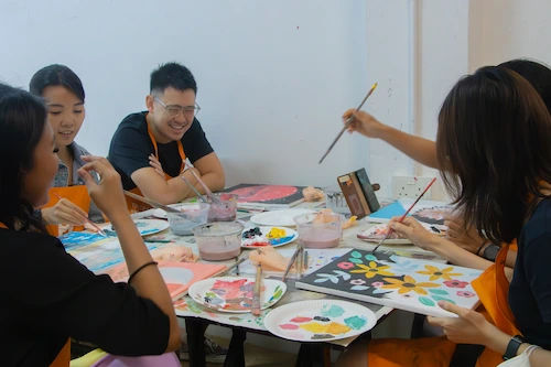 A group painting together at an art jamming session in Singapore