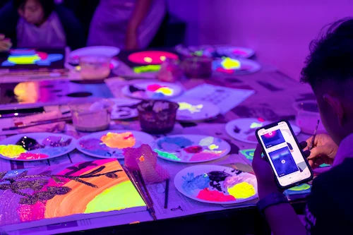 Neon art jamming session painting under blacklight