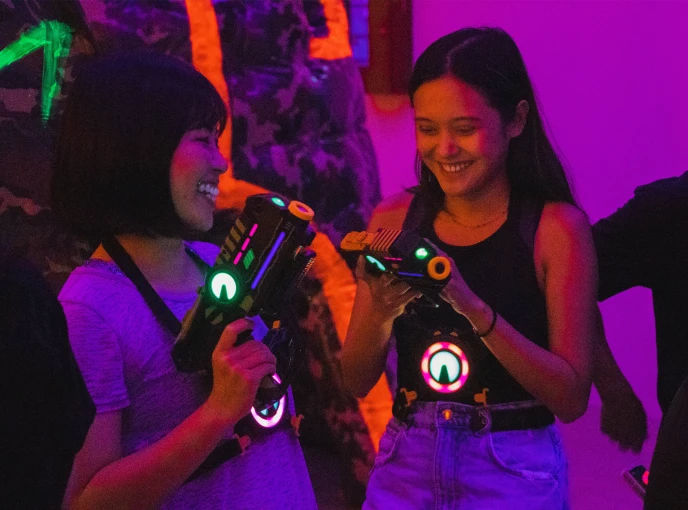 Team members communicating and coordinating during a laser tag team building activity in Singapore