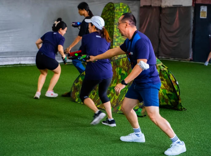 Teams working together during a laser tag corporate event
