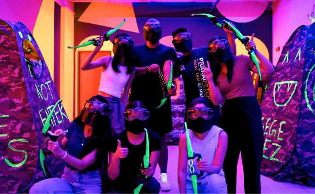 clients in a neon combat archery game in singapore
