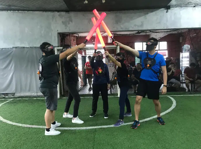 Team of clients playing Saber Tag