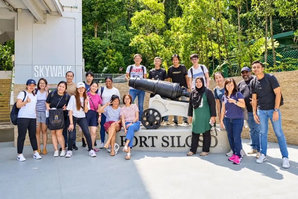 A group pose beside the cannon at Fort Siloso