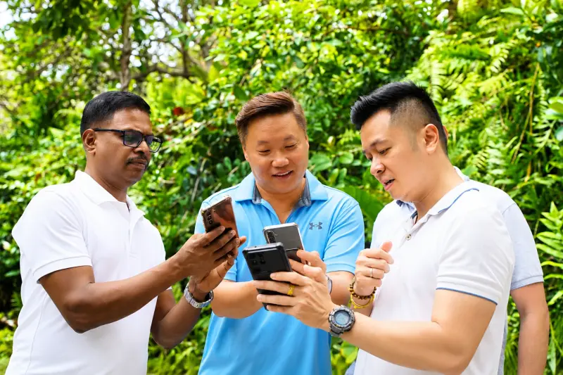 Three teammates compare the clues on their phones