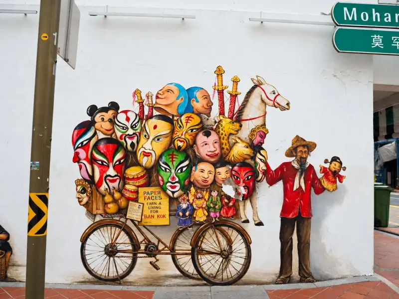 A street mural of opera masks and puppets in Chinatown
