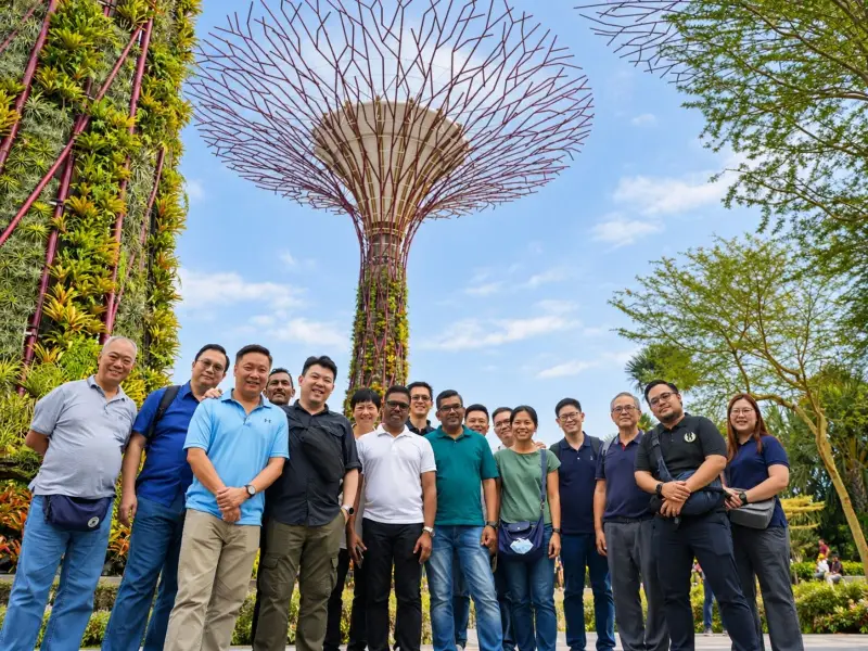 A group pose under a Supertree at Gardens by the Bay