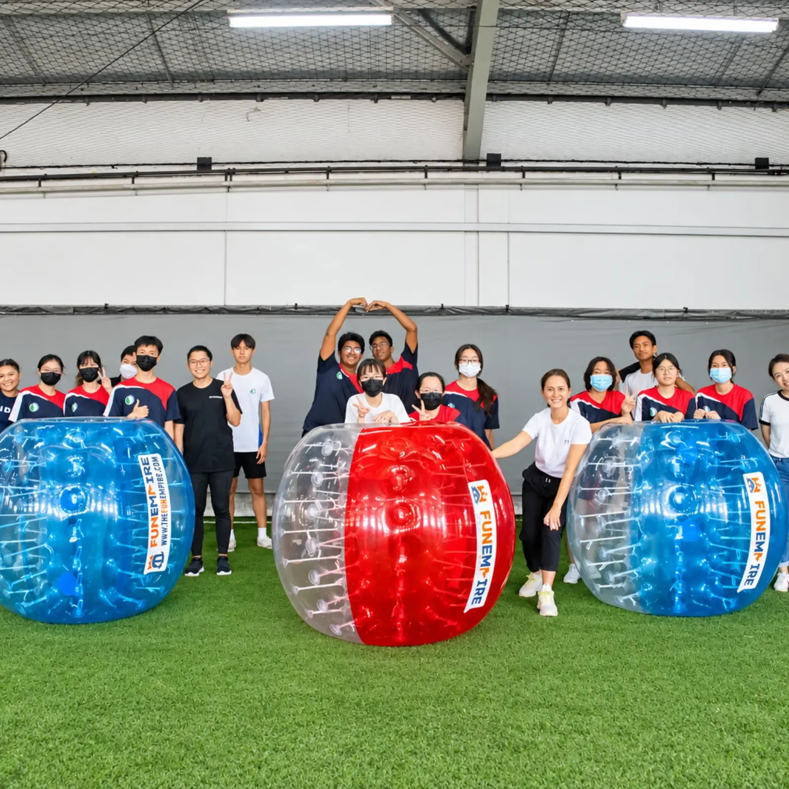 A school cohort lined up behind their bubble suits