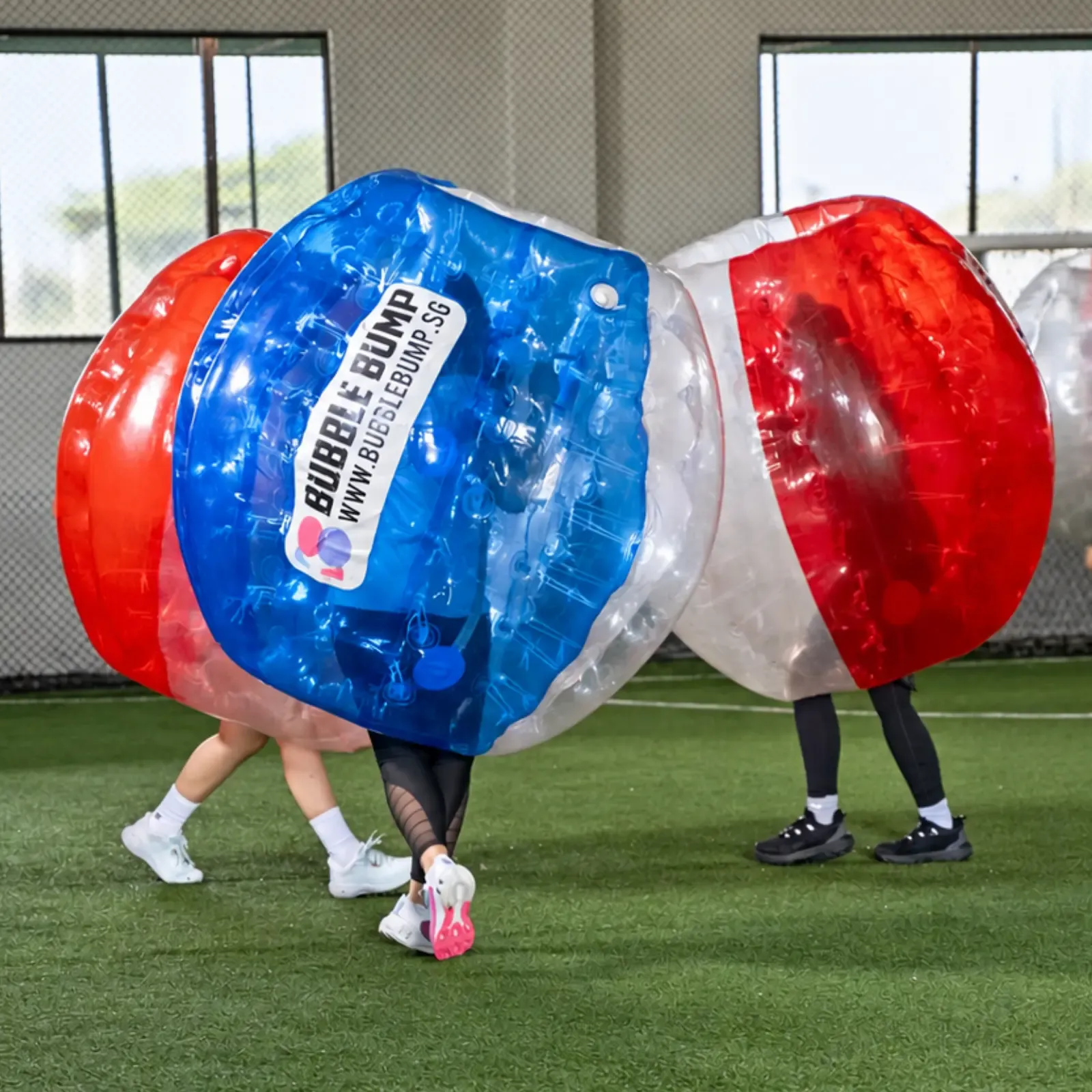 Two players meet head-on in red and blue bubble suits