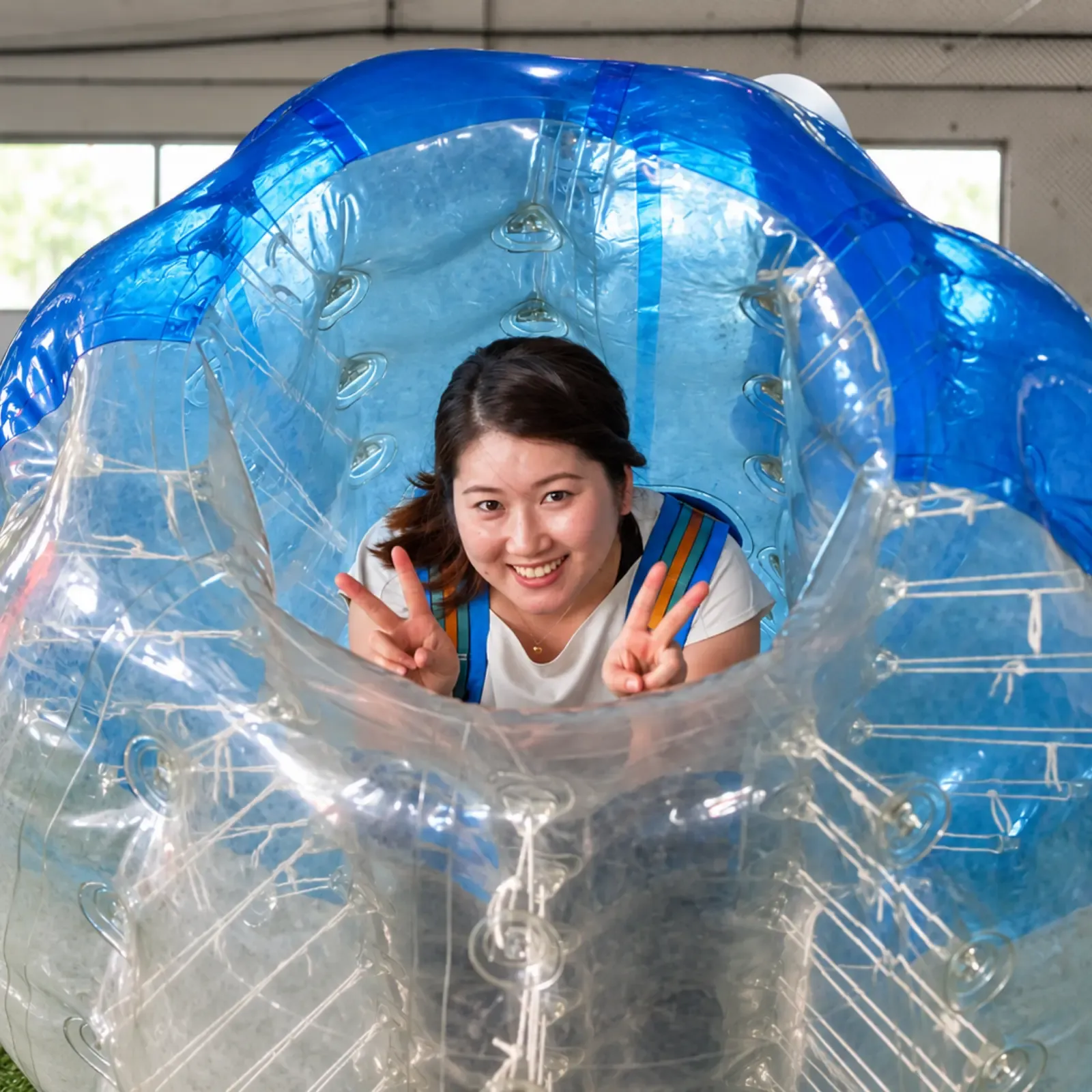 A delighted player peers out from inside a bubble suit