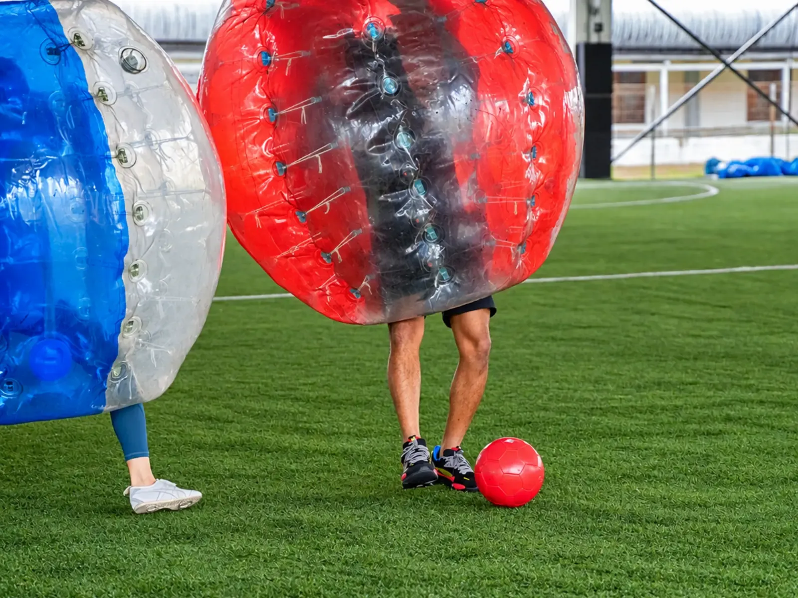 Players close in on the ball in their bubble suits