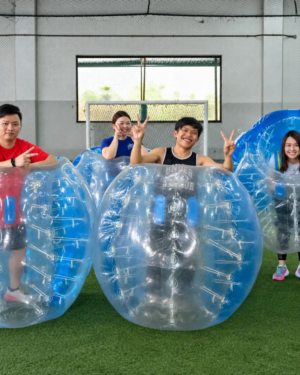 Players cheer from inside their bubble suits