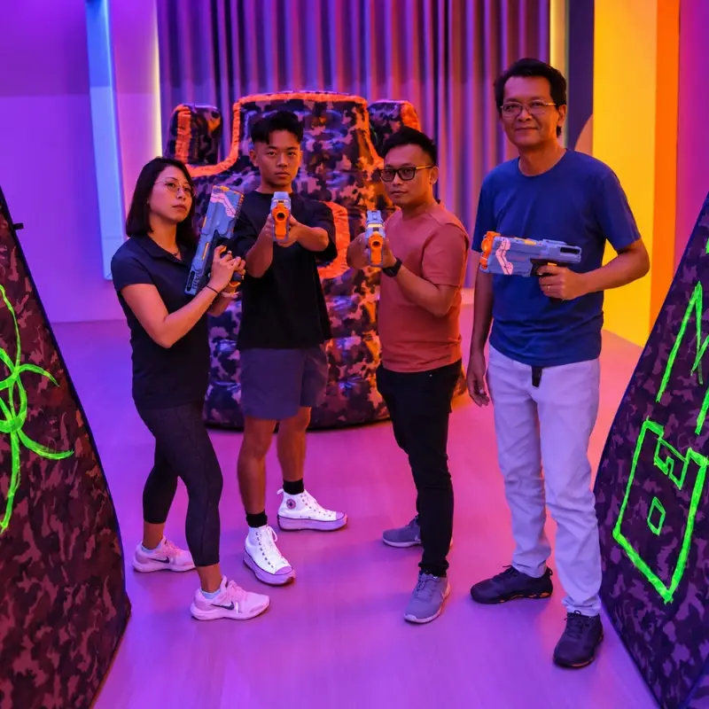Four players pose with their blasters between the bunkers after a session