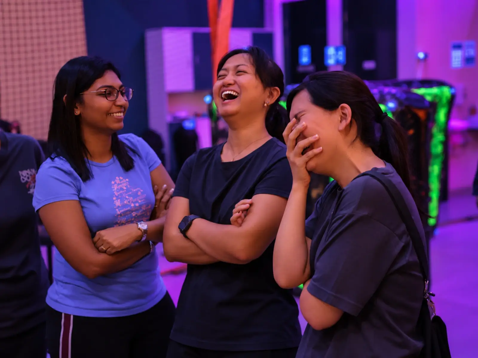 Three teammates laugh together between rounds