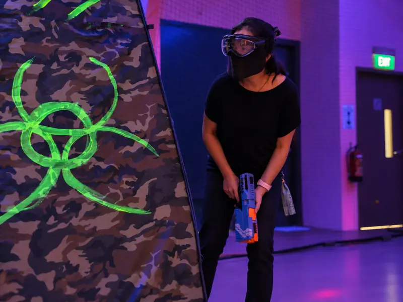 A player steps out from behind a bunker, blaster lowered