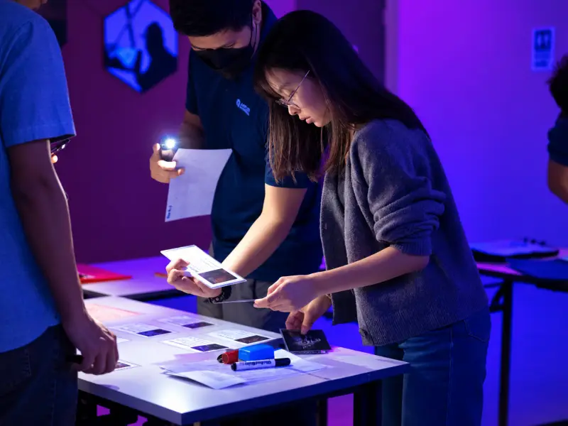 A player reads a clue by torchlight
