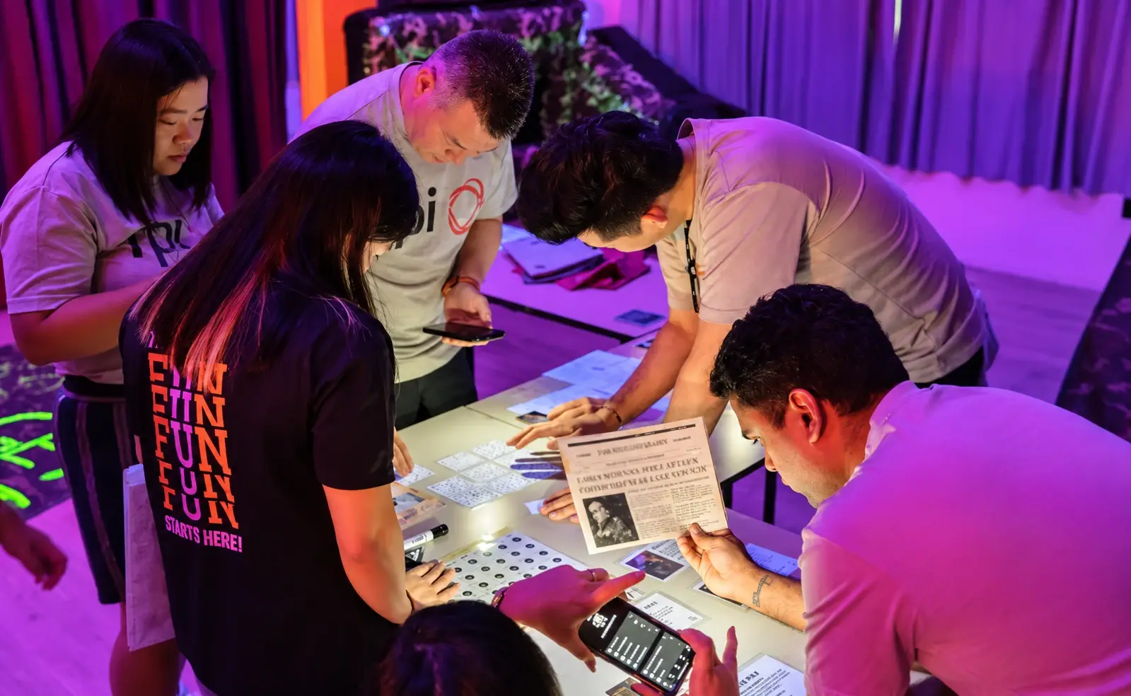A team works on an escape puzzle at a table in the FunEmpire HQ studio