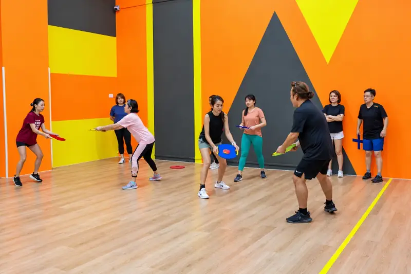 Players face off across the floor with their game pieces in hand