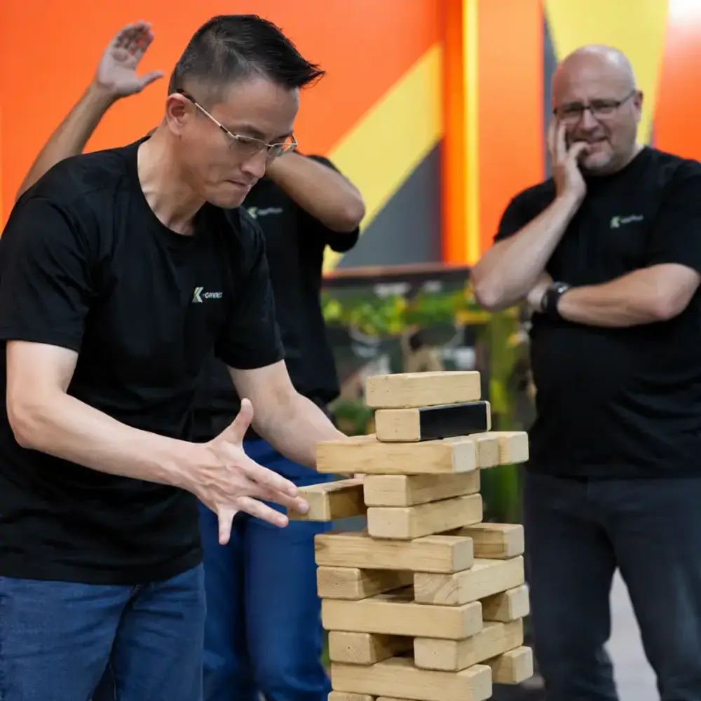 Two colleagues from Kreuz Challenger at the giant Jenga tower