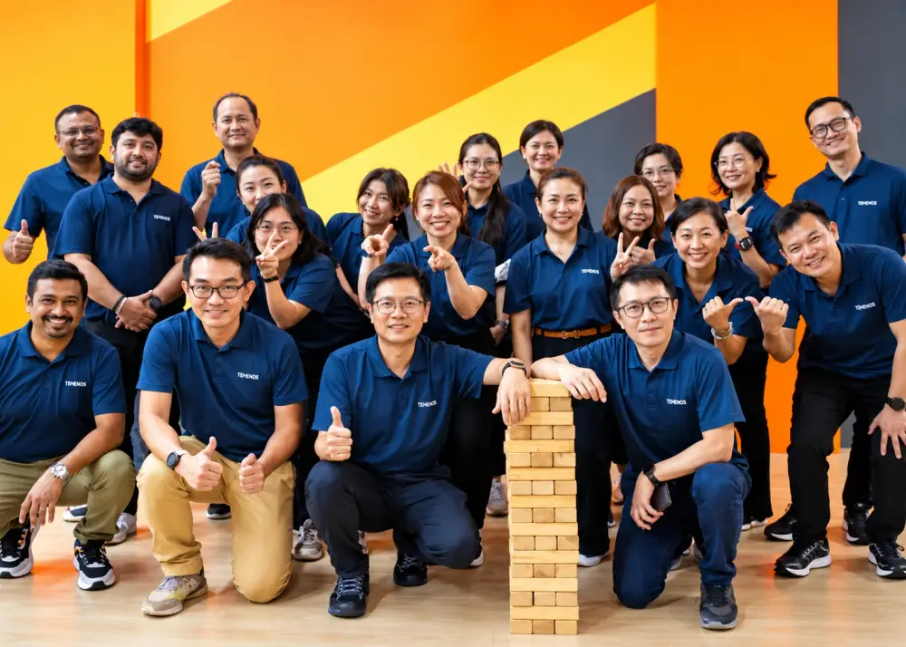 A company team gathered around a giant Jenga tower