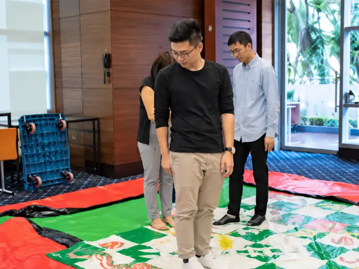 Two players step across a life-sized board game mat