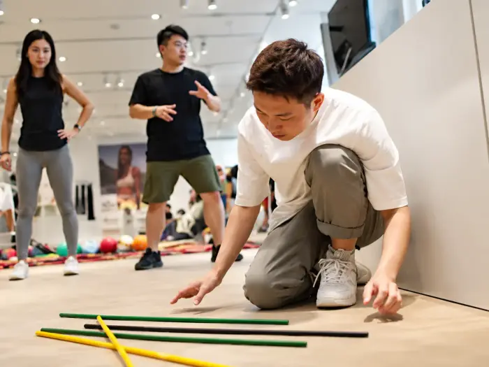 A player lifts one stick from a pile of giant pick up sticks