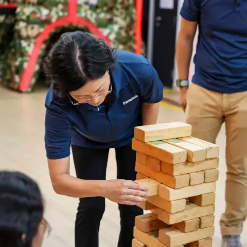 A player places a block on the giant Jenga tower
