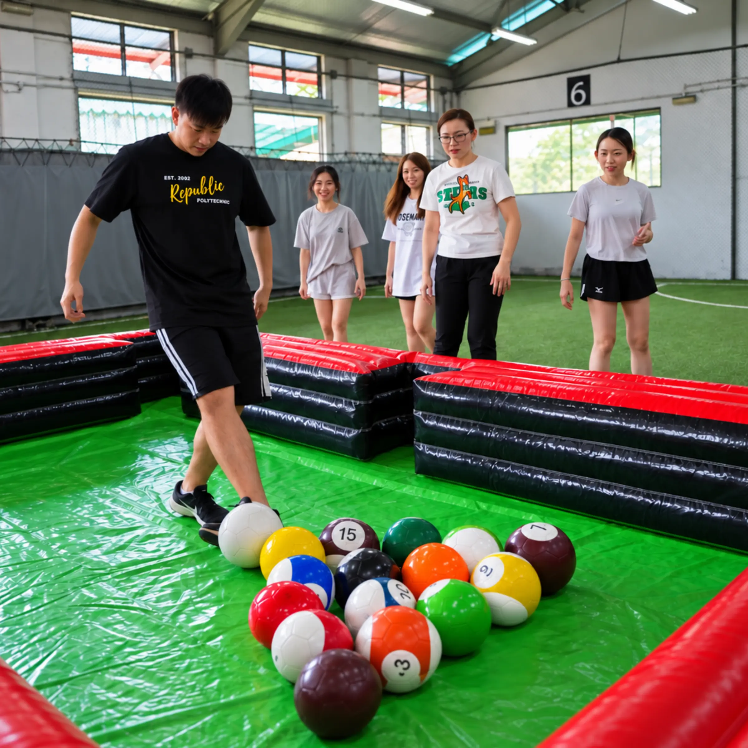 A player takes a shot on the giant Poolball table