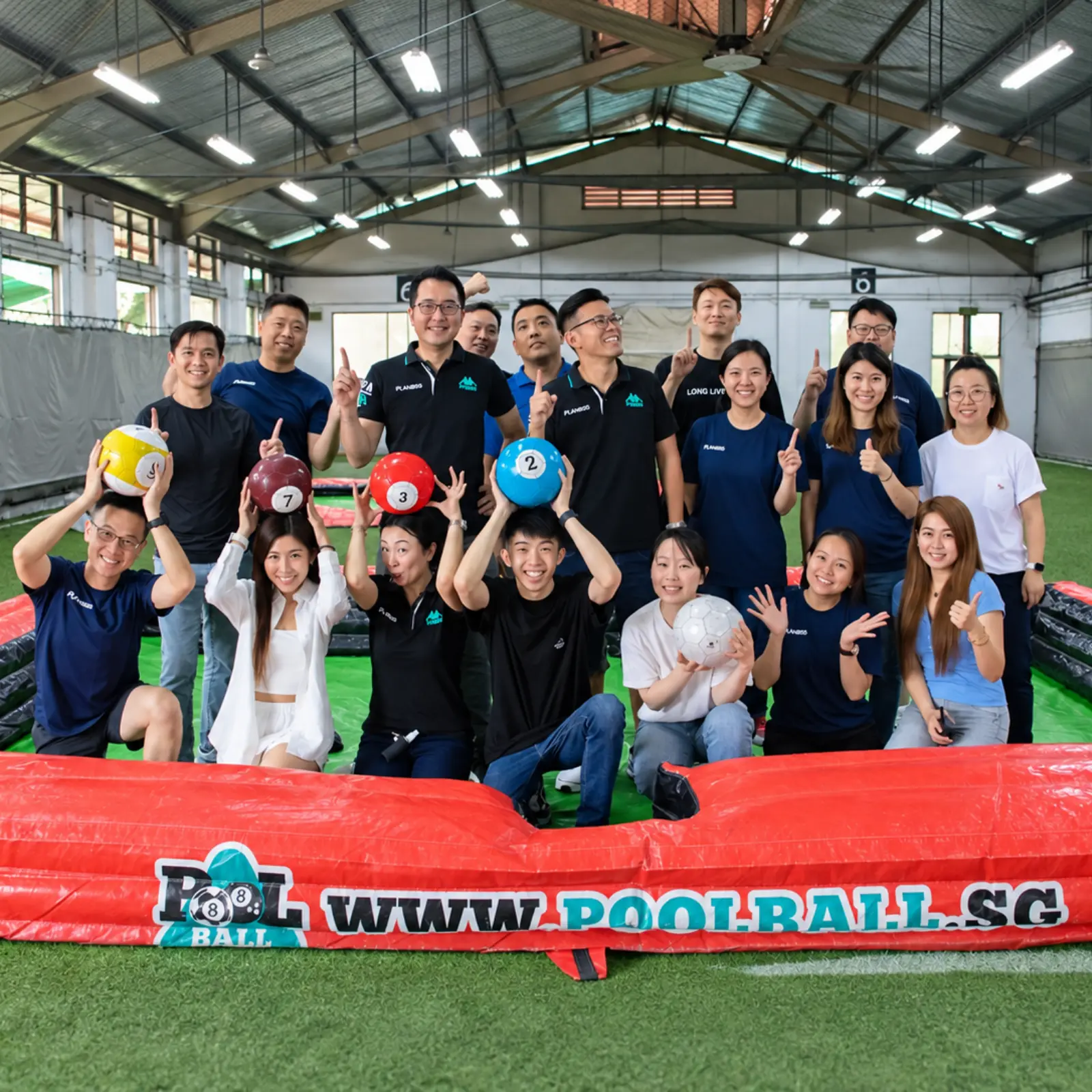 A company group around the Poolball table